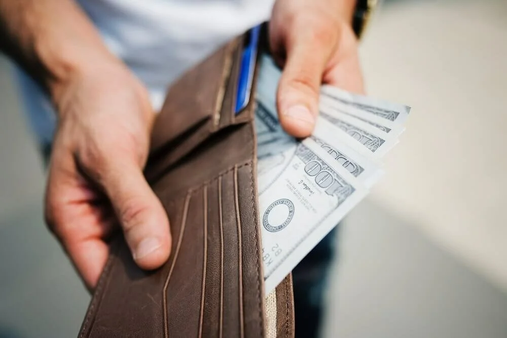 man showing money full of wallet